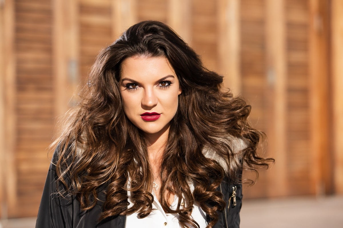 Model portfolio headshot outdoors with direct sunlight